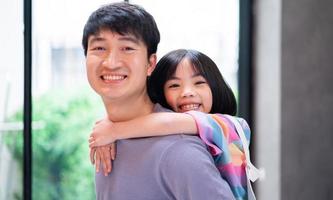 Asian father and daughter at home photo