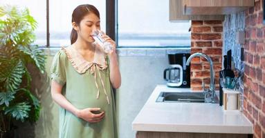 Young Asian woman pregnant relax at home photo