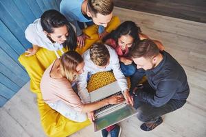 Group of creative young Friends Hanging Social Media Concept. People Together Discussing Creative Project During Work Process, play games or watch video film photo