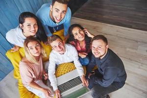 Group of creative young Friends Hanging Social Media Concept. People Together Discussing Creative Project During Work Process, play games or watch video film photo