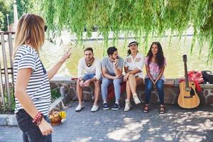 Group of friends relaxing and playing together. Young people chat on the streets, weigh and play games together photo