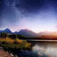 Fantastic starry sky and the milky way over a lake in the park High Tatras. Shtrbske Pleso, Slovakia, Europe photo