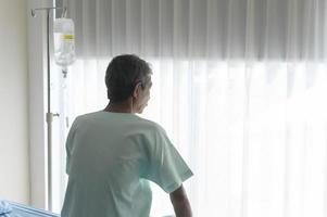 Portrait of senior patient lying on bed in hospital, healthcare and medical concept photo