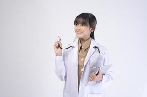 Young female doctor with stethoscope over white background photo