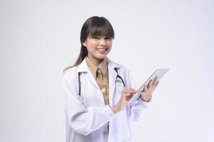 Young female doctor with stethoscope over white background photo