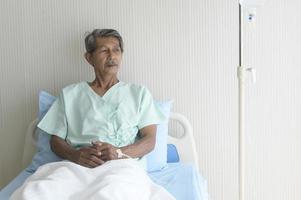 Portrait of senior patient lying on bed in hospital, healthcare and medical concept photo