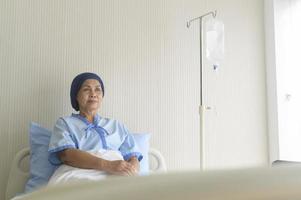 Portrait of senior cancer patient woman wearing head scarf in hospital, healthcare and medical concept photo