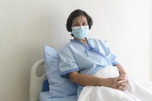 Portrait of senior patient lying on bed in hospital, healthcare and medical concept photo