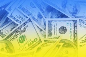 The money is tinted in the color of the Ukrainian flag. The concept of financial assistance to the Ukrainian army photo