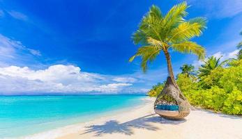 Tropical beach paradise as summer landscape with beach swing or hammock and white sand, calm sea serene beach. Luxury beach vacation summer holiday. Tranquil romantic island nature travel destination