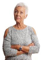 mature woman with arms folded looking away photo