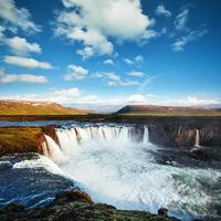 Godafoss waterfall at sunset. Fantastic landscape. Beautiful cumulus clouds. Iceland photo