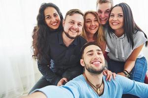 Best friends taking selfie outdoors with backlighting - Happy friendship concept with young people having fun together photo