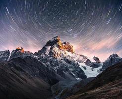 Fantastic starry sky. Snow-capped peaks. Main Caucasian Ridge. Mountain View from Mount Ushba Meyer, Georgia. Europe photo