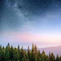 Dairy Star Trek in the woods. Dramatic and picturesque scene. Fantastic starry sky and the milky way photo