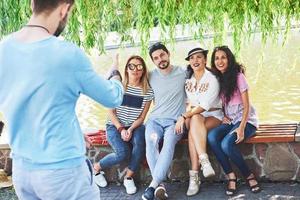 Group of friends relaxing and playing together. Young people chat on the streets, weigh and play games together photo