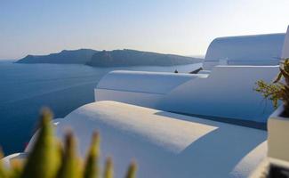 Roof of hotels on the background of the Mediterranean Sea on the island of Santorini, Oia village. photo