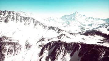 panoramic mountain view of snow capped peaks and glaciers photo