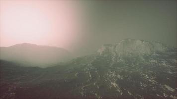 Rocks and mountains in deep fog photo