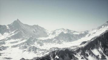 panoramic mountain view of snow capped peaks and glaciers photo