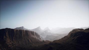 Rocks and mountains in deep fog photo