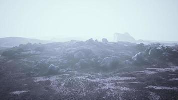 foggy mountain landscape with snow cornice over abyss inside cloud photo