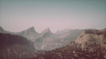 Rocks and mountains in deep fog photo