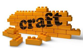 craft word on yellow brick wall photo