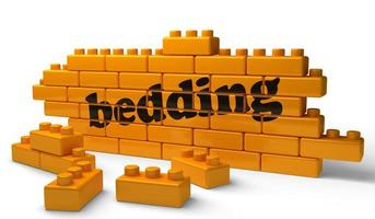 bedding word on yellow brick wall photo