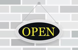 cartel de tienda abierta para tienda. simple signo ovalado en color negro amarillo sobre textura de pared de ladrillo blanco.