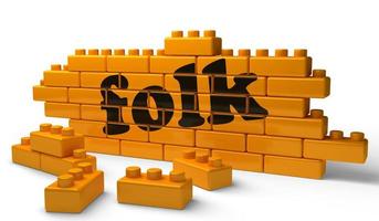 folk word on yellow brick wall photo