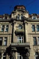 Building facade. Old building exterior with windows and lanterns. Historic building structure. Architectural structure. Urban architecture and construction. City building. Town house. photo