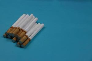 a collection of cigarettes arranged on a blue background photo