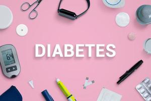 Diabetes top view, flat lay composition with text surrounded by tools and supplies photo