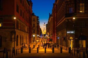 Night street with buildings and lights in Stockholm city historical centre photo