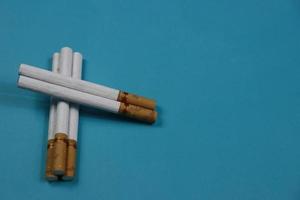 a collection of cigarettes arranged on a blue background photo