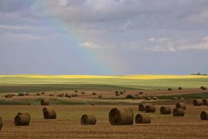 Rainbow behind hay bales in scenic Saskatchewan photo