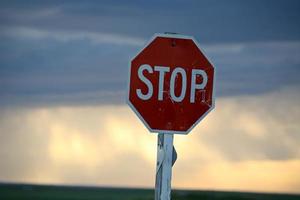 Storm clouds building behind a Stop sign in Saskatchewan photo