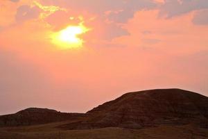 Rising sun behind thin clouds in scenic Saskatchewan photo