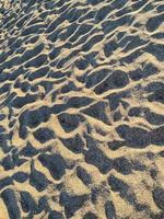 textura de arena limpia en la playa, cuadro completo foto