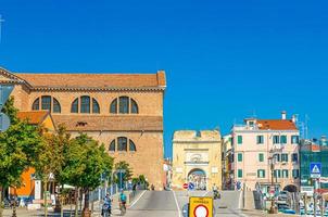 Chioggia, Italy, September 16, 2019 Chioggia street with Porta Santa Maria o Porta Garibaldi gate photo