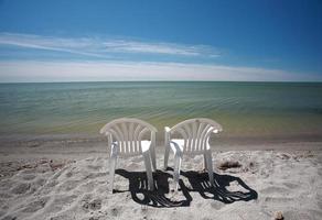 lawn chairs along beach of Lake Winnipeg photo