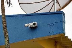 Two white security cameras photo