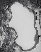 Closeup view of frozen lake with borders of water surrounding it photo