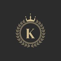 Initial Letter K Heraldic Royal Frame with Crown and Laurel Wreath. Simple Classic Emblem. Round Composition. Graphics Style. Art Elements for Logo Design Vector Illustration