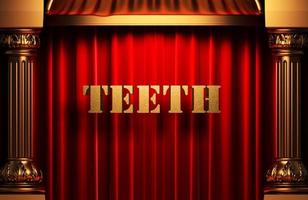 dientes palabra dorada en cortina roja foto