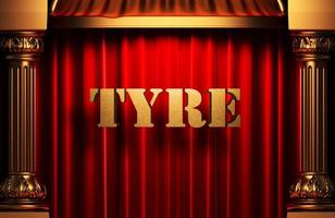 tyre golden word on red curtain photo