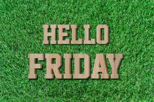 Hello friday made from wooden alphabet on green grass. photo
