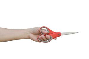 hand holding red scissors isolated on white background with clipping path. photo