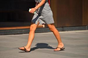 woman in short gray dress goes photo